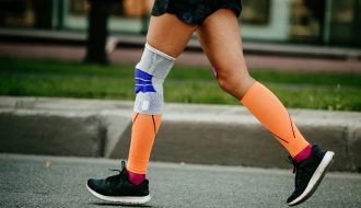 athlete running with compression socks